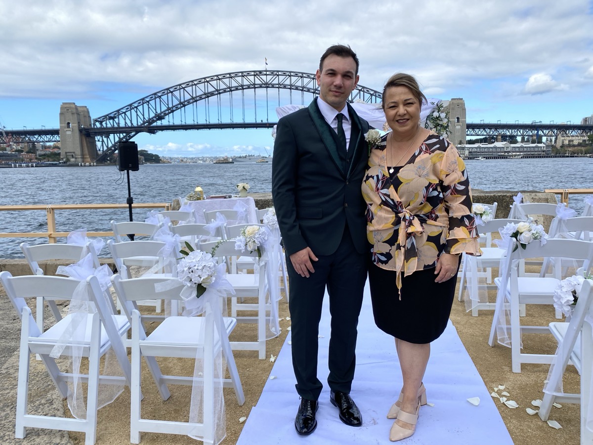 A ceremony set up on the harbour with the Sydney Harbour Bridge behind